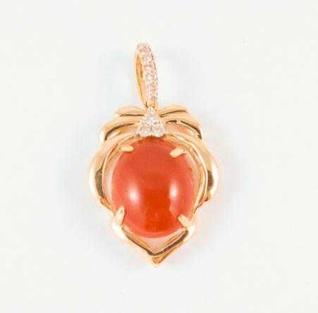 Appraisal: CORAL DIAMOND AND FOURTEEN KARAT GOLD PENDANT with round-cut diamonds