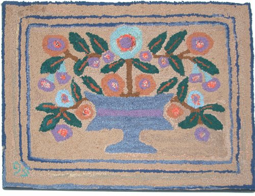 Appraisal: a hooked rug in blue orange and brown Artist th