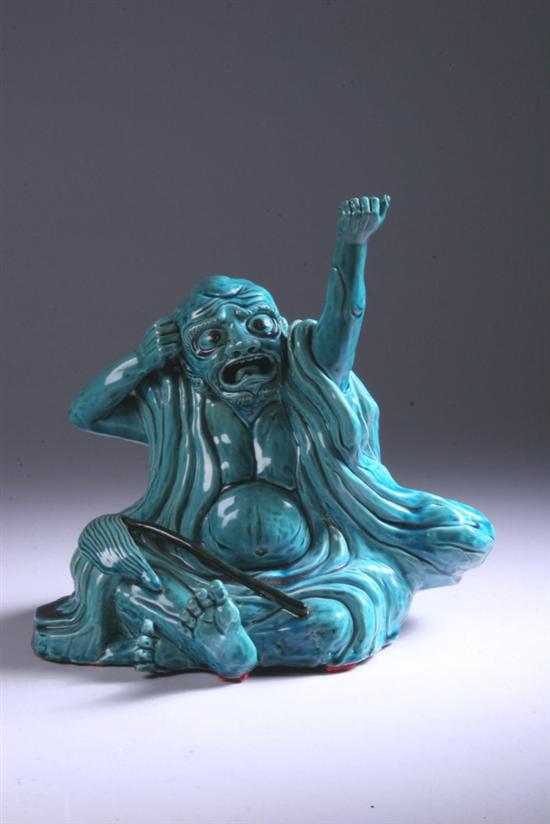 Appraisal: CHINESE TURQUOISE PORCELAIN FIGURE OF MAN Qing Dynasty Seated wearing