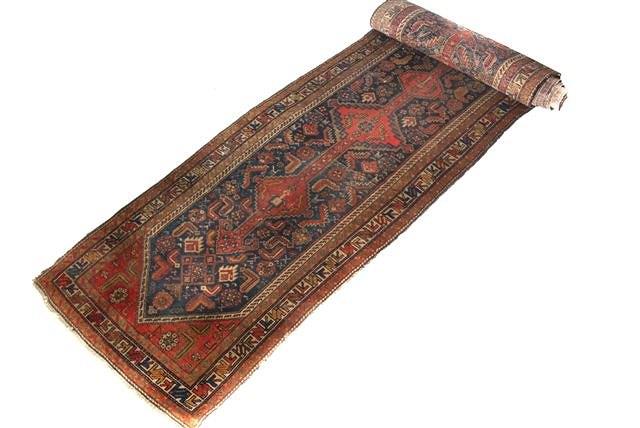 Appraisal: AN HAMADAN BLUE GROUND RUNNER with geometric motifs and triple