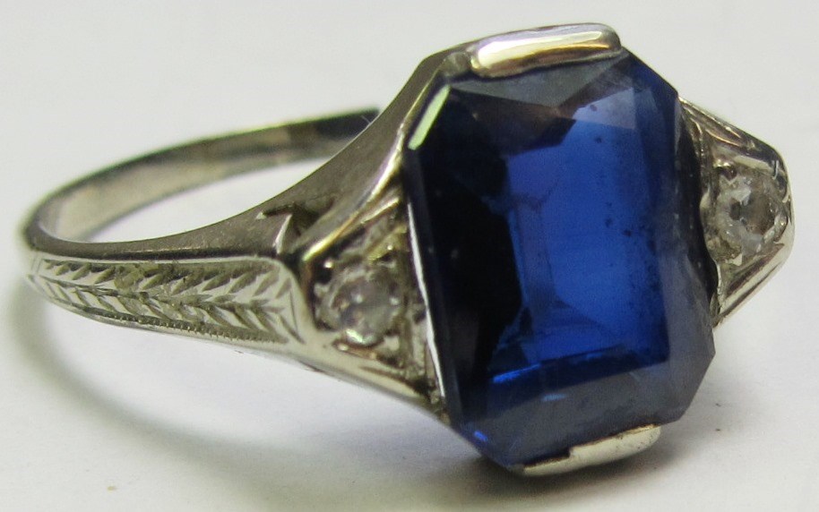 Appraisal: A white gold synthetic sapphire and diamond set three stone