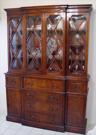 Appraisal: BUBBLE GLASS MAHOGANY BREAKFRONT SECRETARY BOOKCASE Richly grained drawer fronts