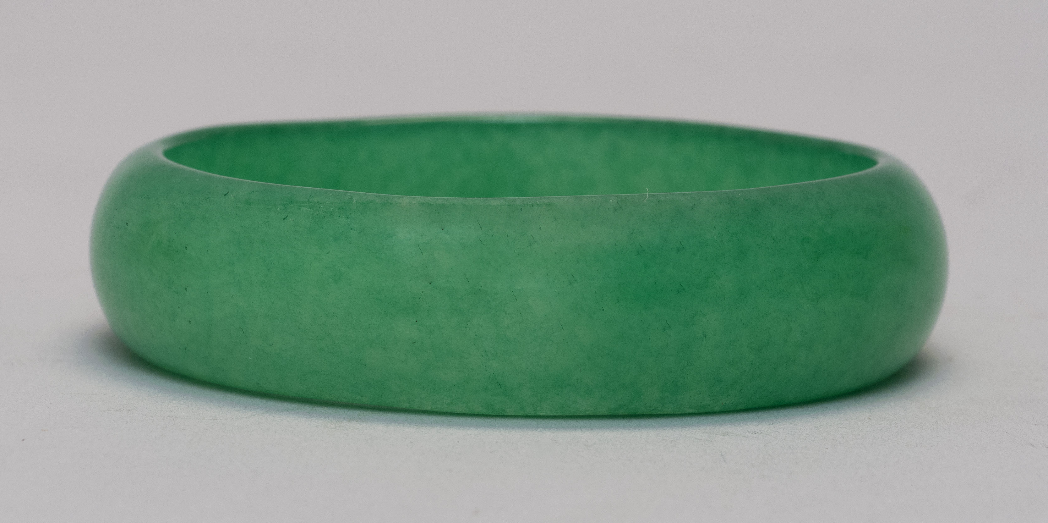 Appraisal: GREEN JADE BANGLE BRACELET Exterior diameter cm interior diameter cm