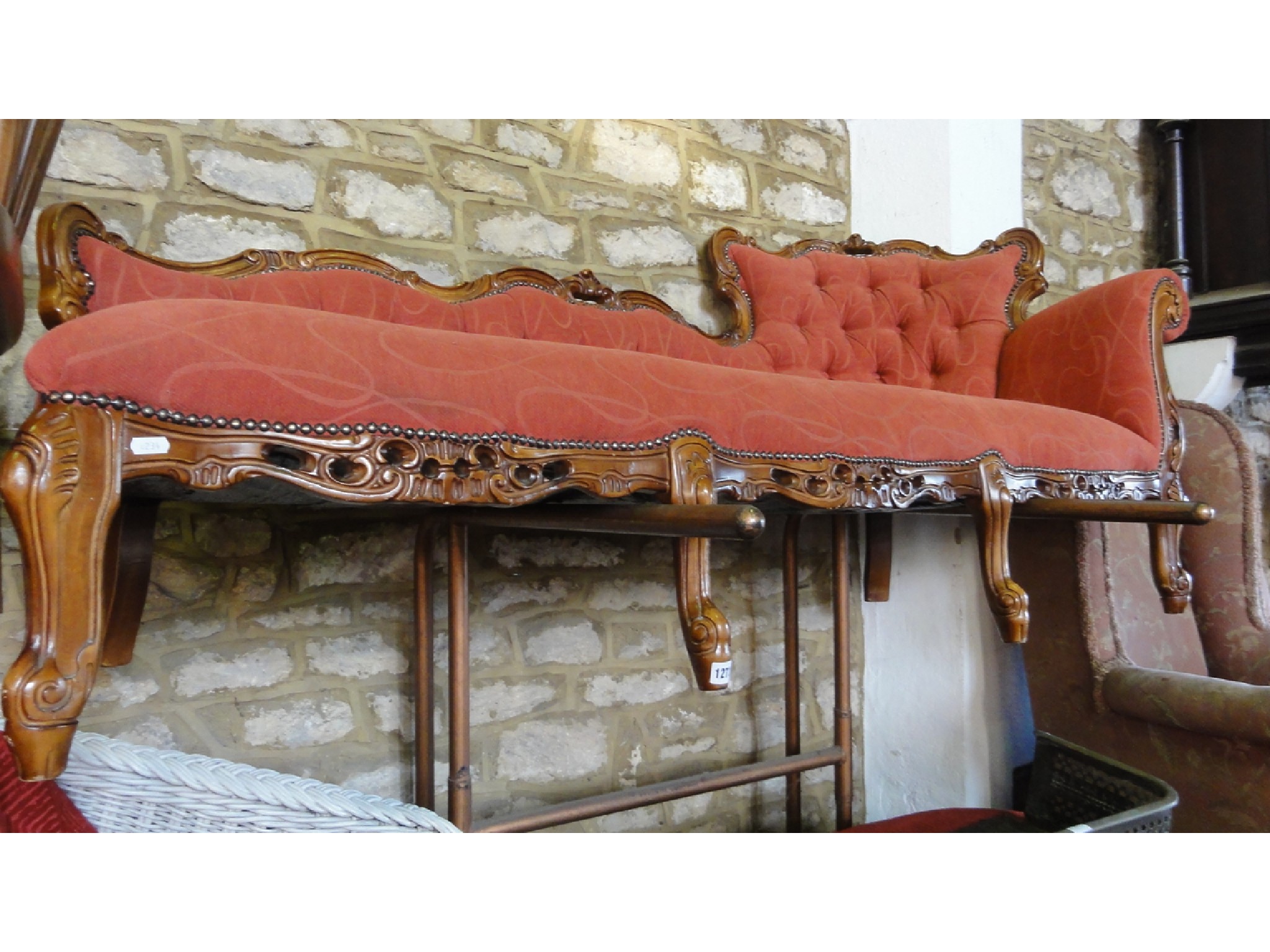 Appraisal: A reproduction chaise lounge couch with upholstered seat and button