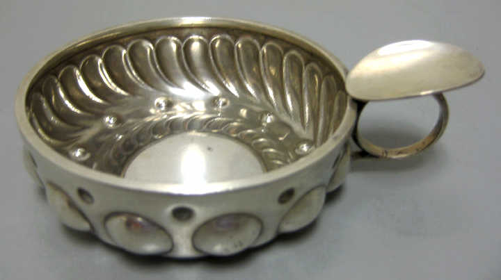 Appraisal: FRENCH SILVER WINE TASTER C Round bowl with chased lobs