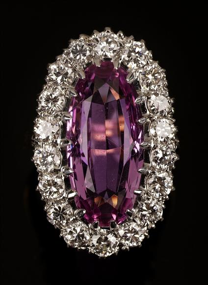 Appraisal: A pink topaz and diamond cluster ring the central oval