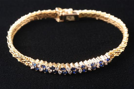 Appraisal: K YELLOW GOLD SAPPHIRE AND DIAMOND BRACELET Woven bracelet with