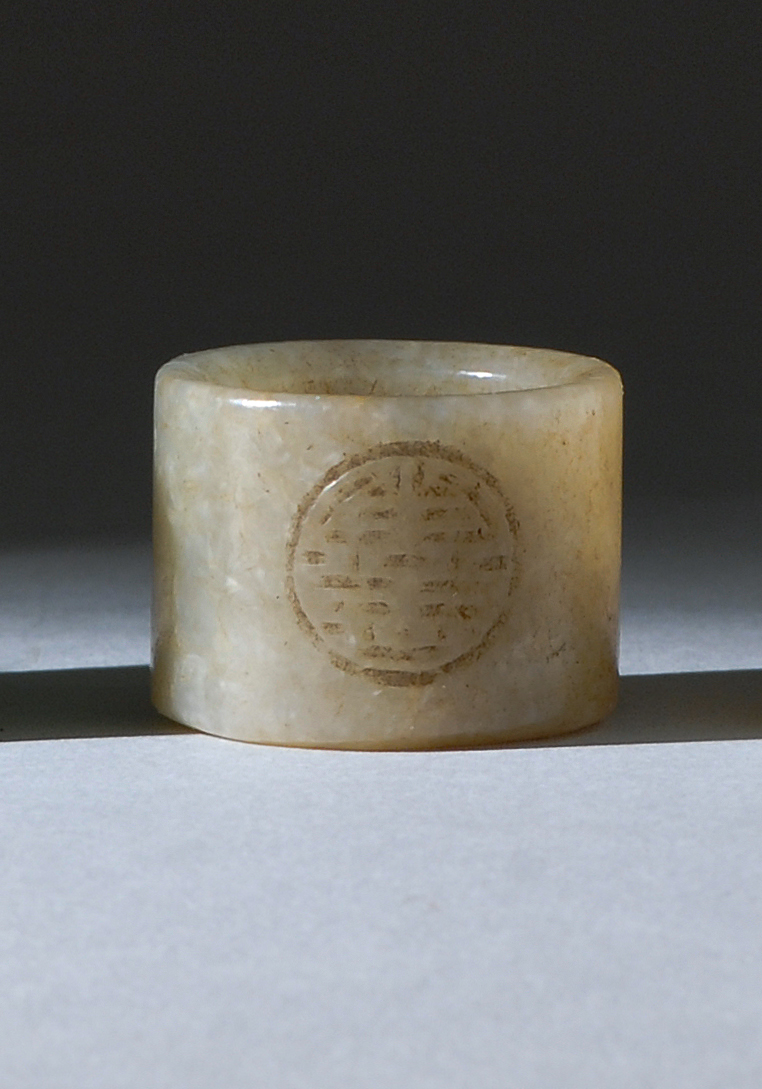 Appraisal: PALE BROWN JADE SCHOLAR'S RING th CenturyWith two circular shou