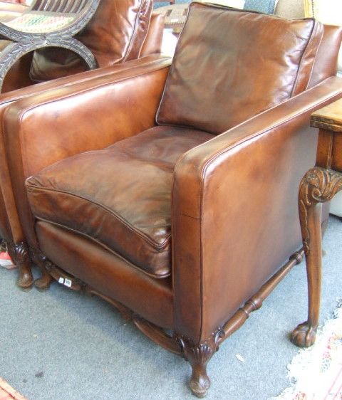 Appraisal: A pair of th century walnut framed leather upholstered square