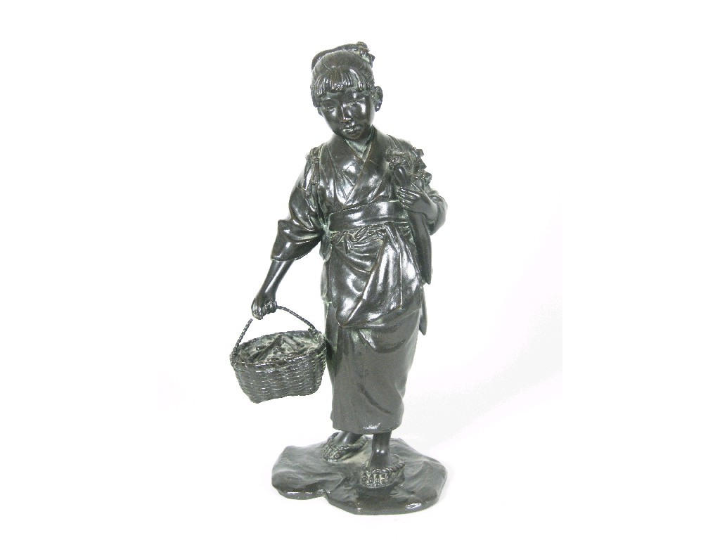 Appraisal: A Japanese bronze Figure of young lady holding iris and