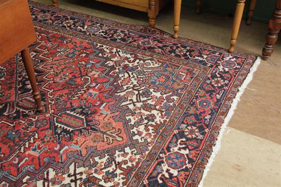 Appraisal: HERIZ RUG Hand knotted with geometric medallion on rust ground