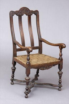 Appraisal: WILLIAM AND MARY CARVED WALNUT ARMCHAIR The shaped top rail