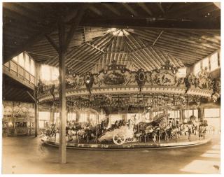 Appraisal: Photographs of Carousel with Cherubic Details Two photographs of a