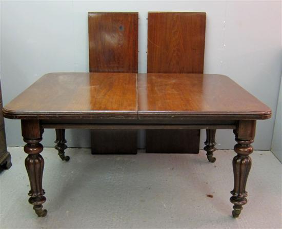 Appraisal: th century mahogany dining table with two extra leaves on