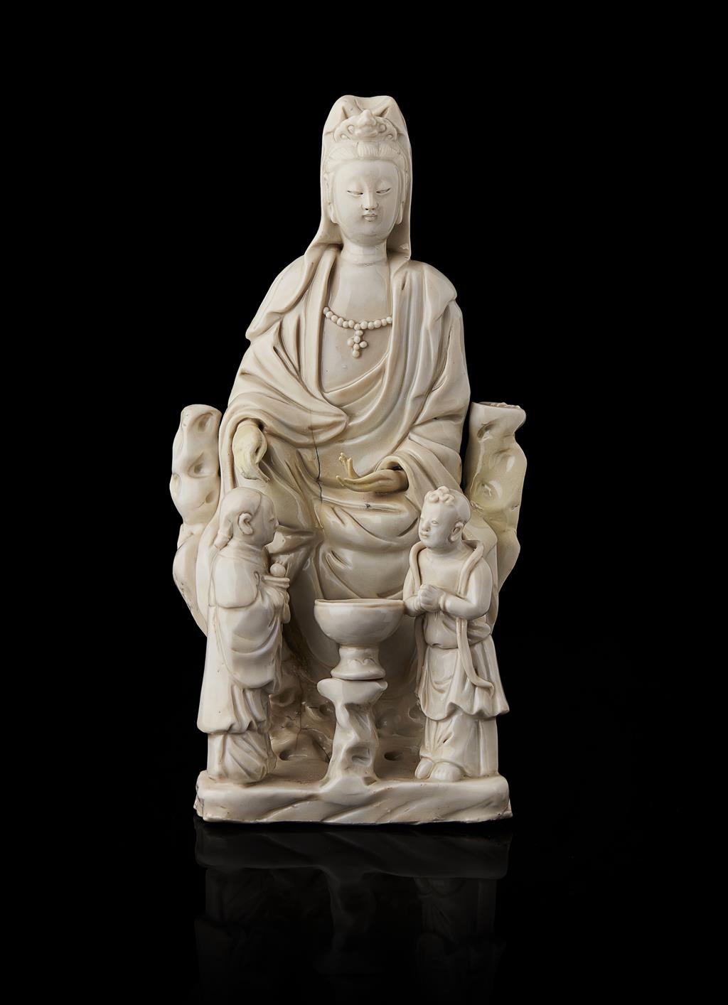 Appraisal: BLANC DE CHINE SEATED FIGURE OF GUANYIN seated in the