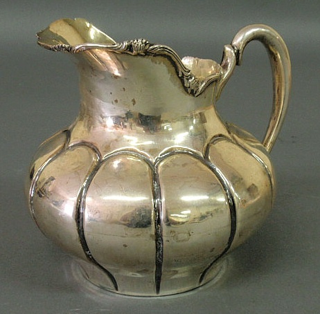 Appraisal: Peruvian silver water pitcher with a floral chased rim and