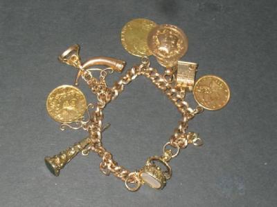 Appraisal: A CT GOLD CHARM BRACELET hanging with three coins a