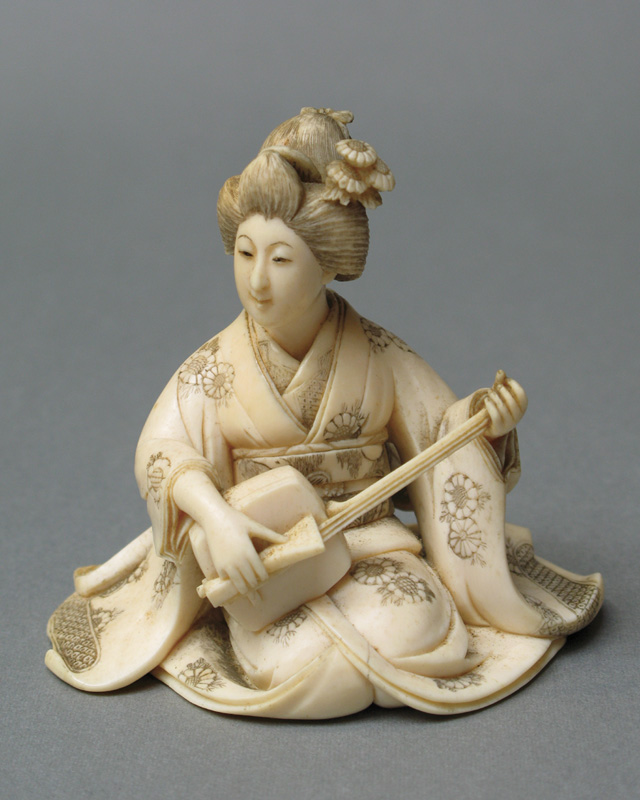 Appraisal: JAPANESE CARVED IVORY FIGURE of a seated woman in traditional