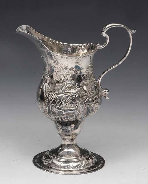 Appraisal: A Georgian silver jugof baluster form on pedestal foot with