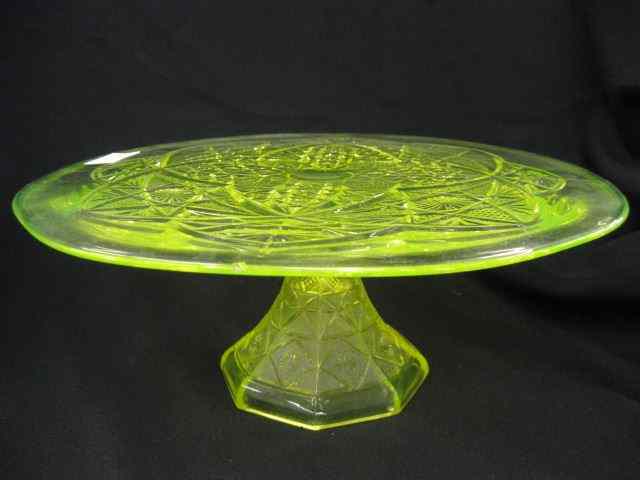 Appraisal: Vaseline Glass Cake Stand ornate design '' diameter pedestal base