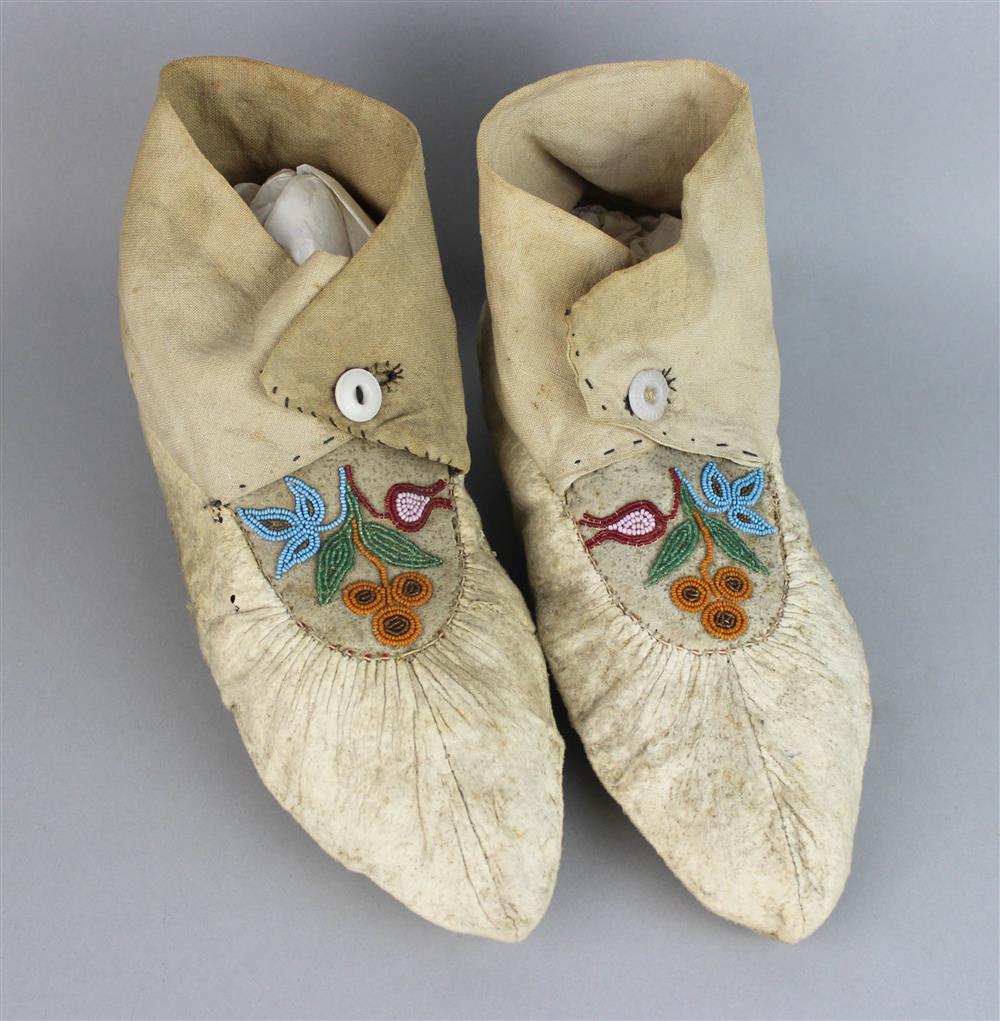 Appraisal: EASTERN WOODLANDS BEAD DECORATED HIDE WOMAN'S MOCCASINS buttoned cotton cuffs