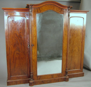 Appraisal: A Victorian mahogany breakfront triple wardrobe the moulded cornice above