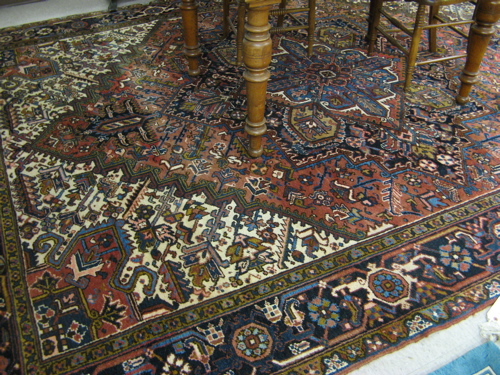 Appraisal: SEMI-ANTIQUE PERSIAN HERIZ CARPET centering a large geometric medallion with