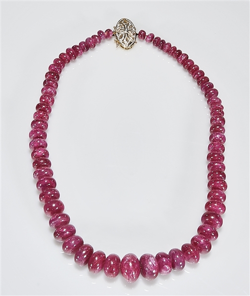 Appraisal: African dyed ruby bead necklace k gold and diamond pendant