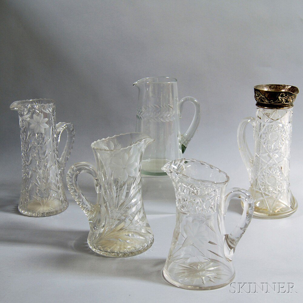 Appraisal: Five Etched and Cut Glass Pitchers four with floral designs