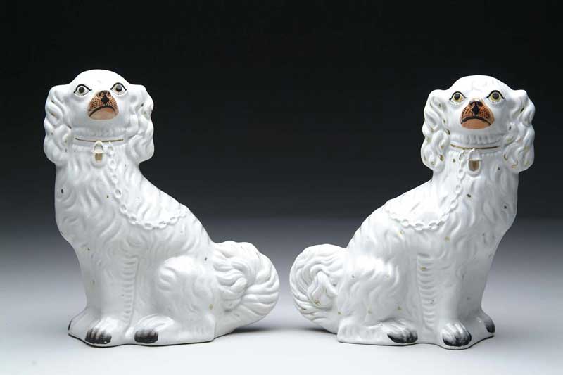 Appraisal: LARGE PAIR OF STAFFORDSHIRE SEATED SPANIELS Orange black and gold