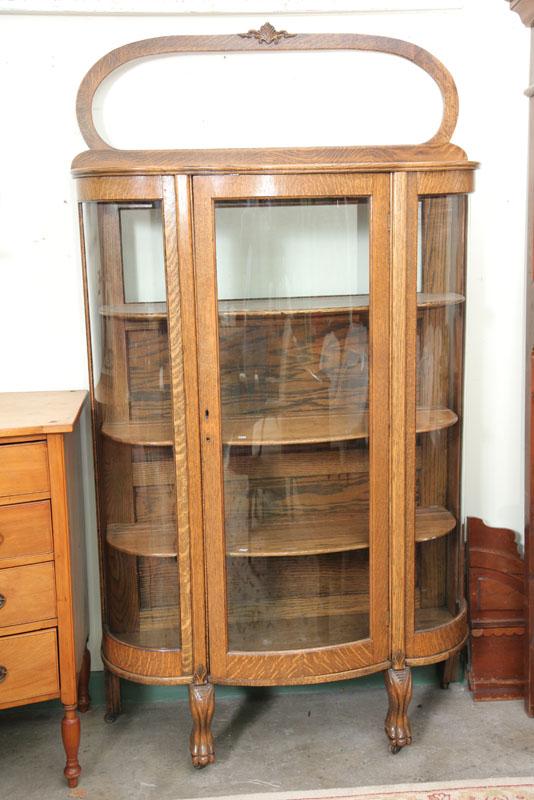 Appraisal: CHINA CABINET Oak with an oval crest curved glass sides