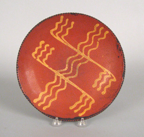 Appraisal: Redware pie plate th c with yellow slip decoration dia