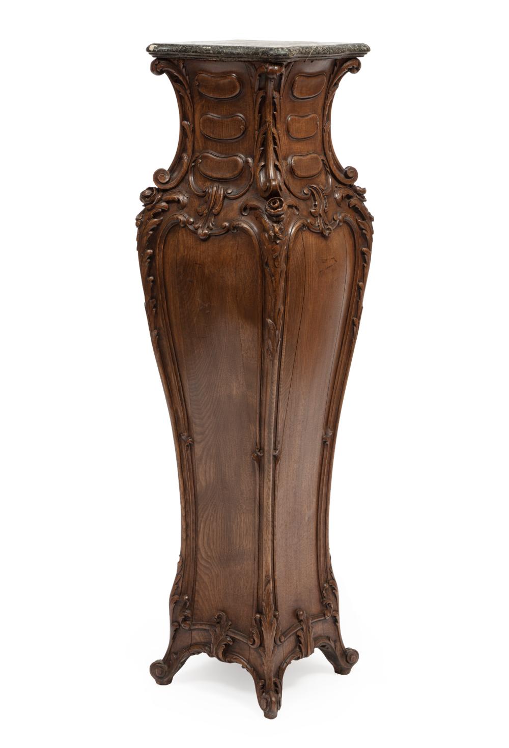 Appraisal: Continental Rococo-Style Carved Oak Pedestal black marble top bombe form