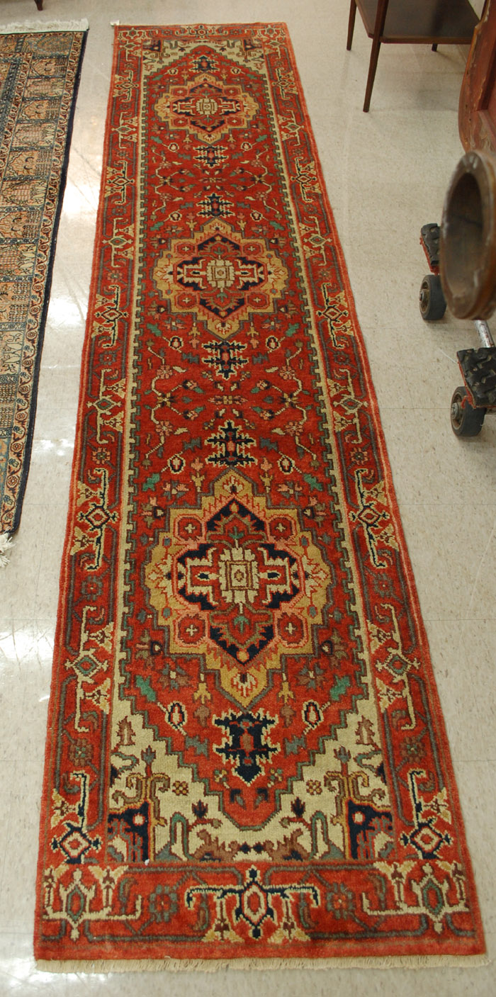 Appraisal: HAND KNOTTED ORIENTAL HALL RUG Persian Serapi design with red