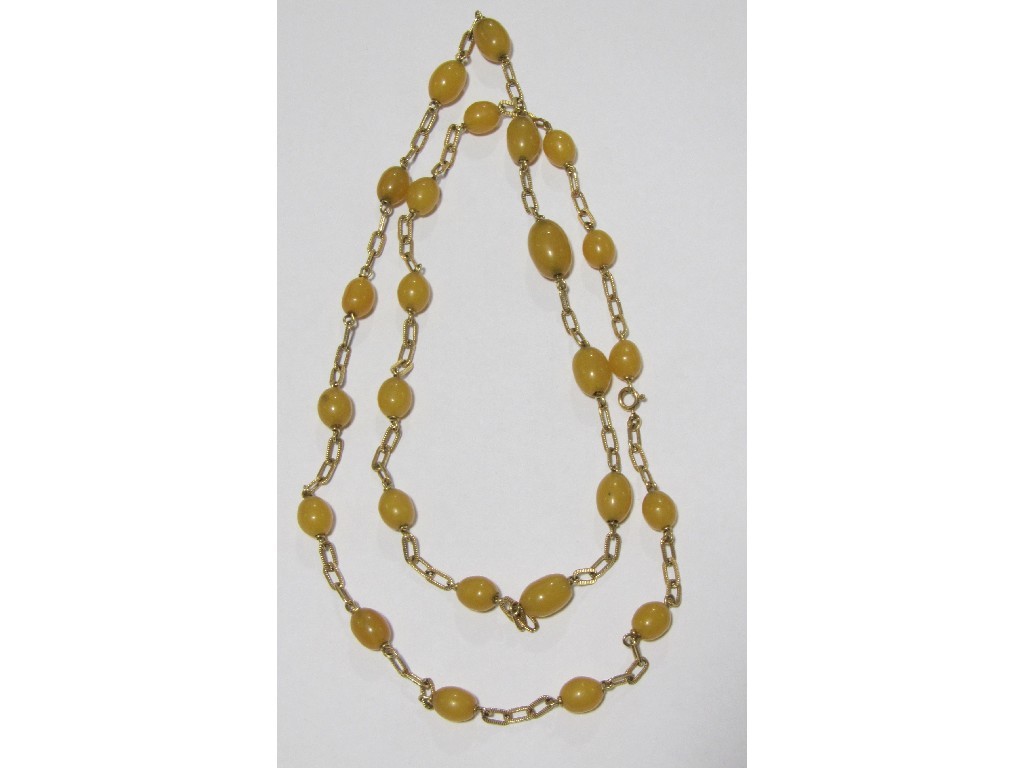 Appraisal: Eighteen carat gold butterscotch amber spacer necklace Approximately inches