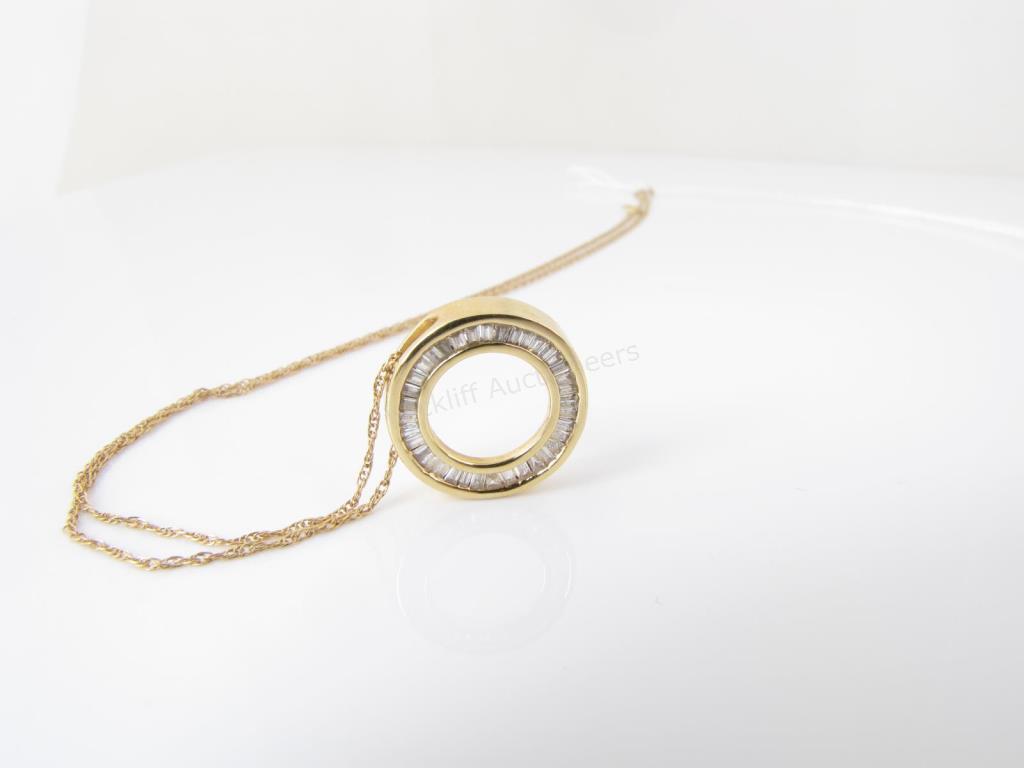 Appraisal: A K yellow gold open circle pendant with approximately ctw