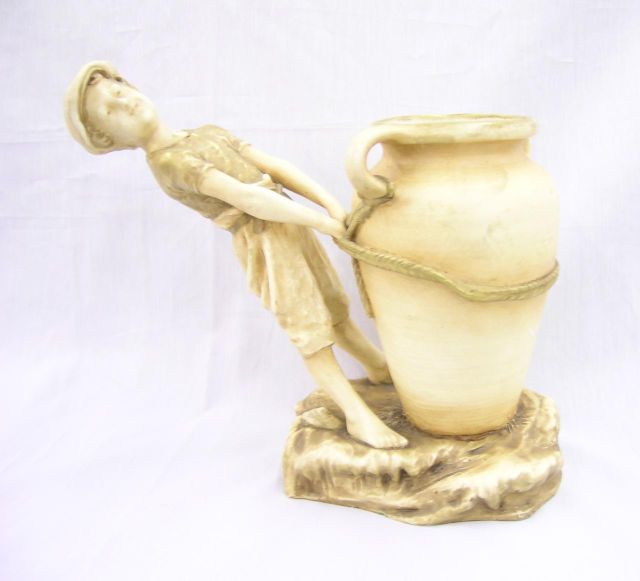 Appraisal: Royal Dux Amphora figural vase depicting young boy with handled