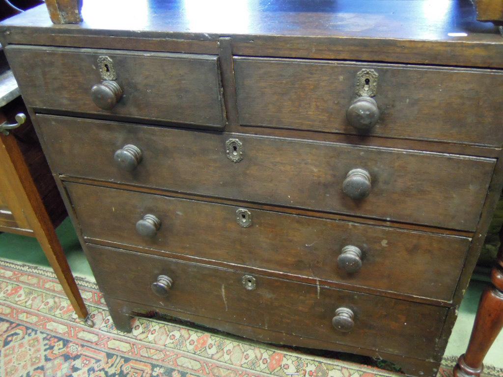 Appraisal: A Georgian oak caddy top chest fitted with three long