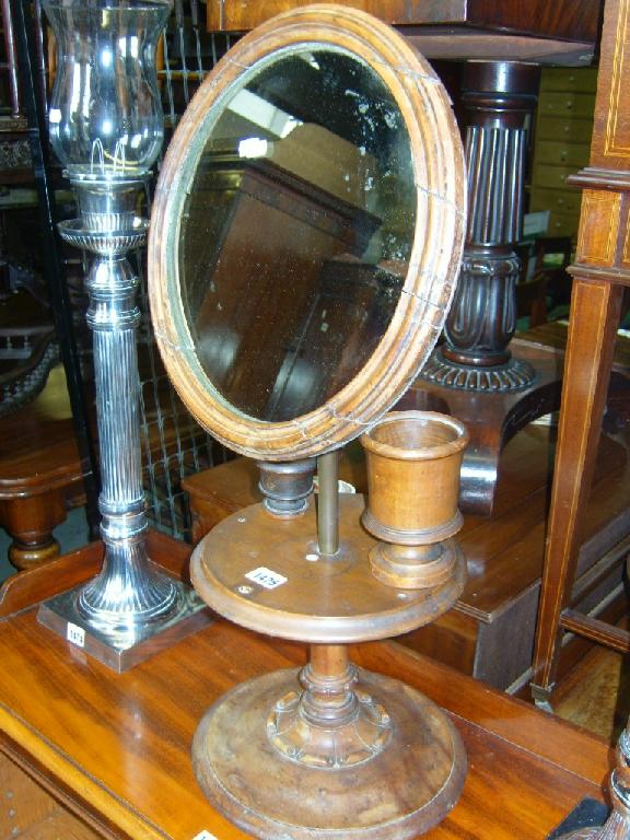 Appraisal: A th century walnut shaving stand with circular mirror and