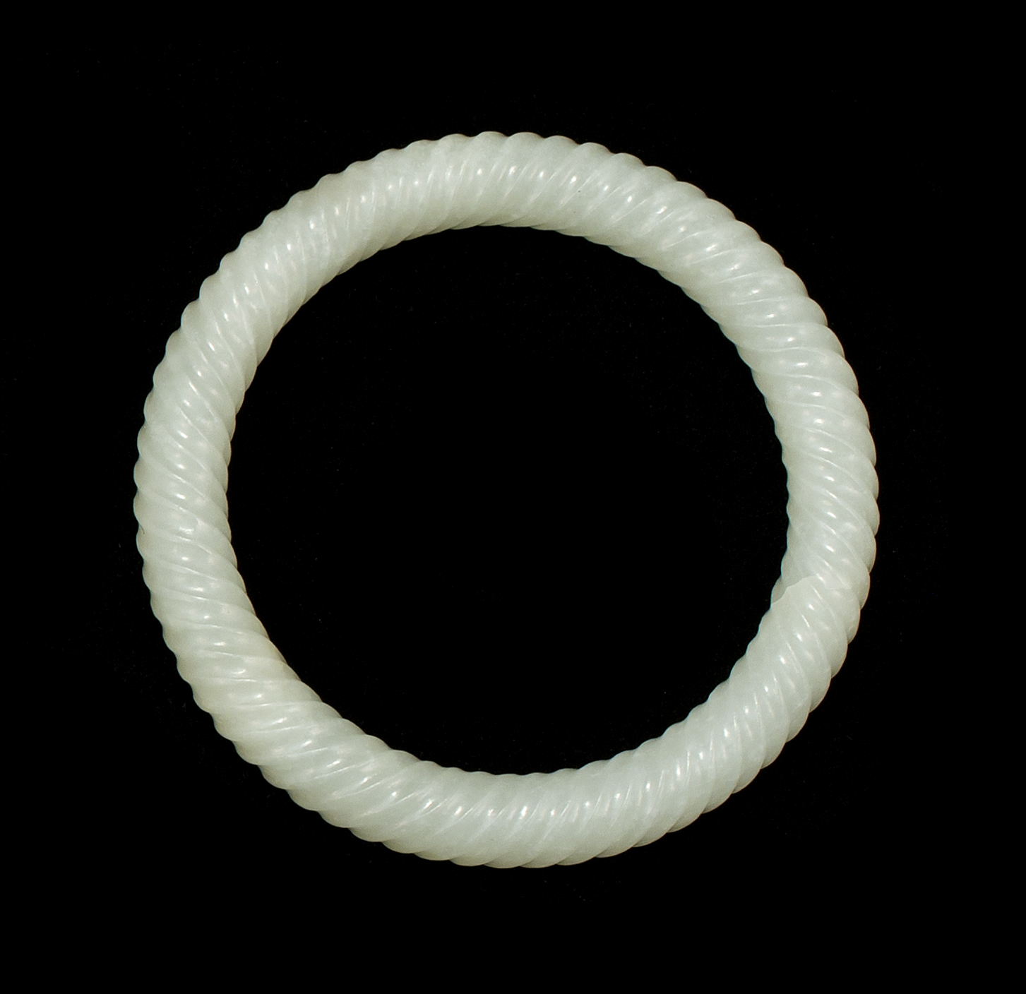 Appraisal: WHITE JADE BANGLE BRACELET In a rope-twist design Exterior diameter