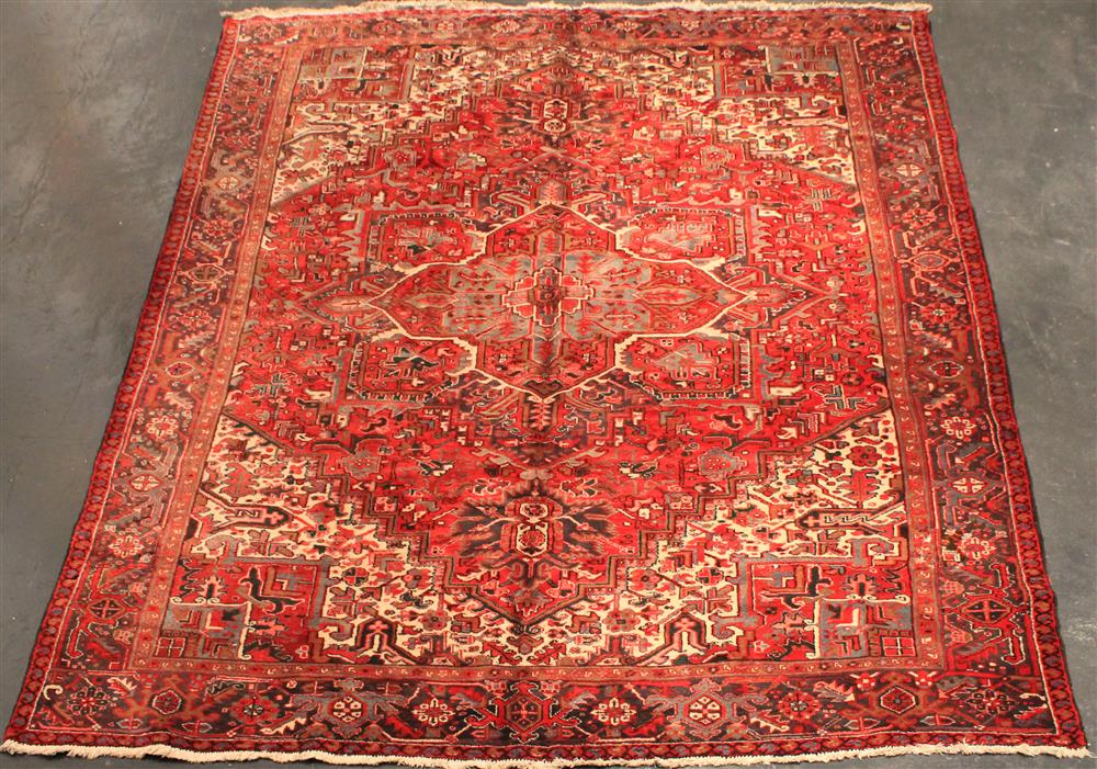 Appraisal: PERSIAN HERIZ central medallion primarily in red blue-grey grey-brown cream