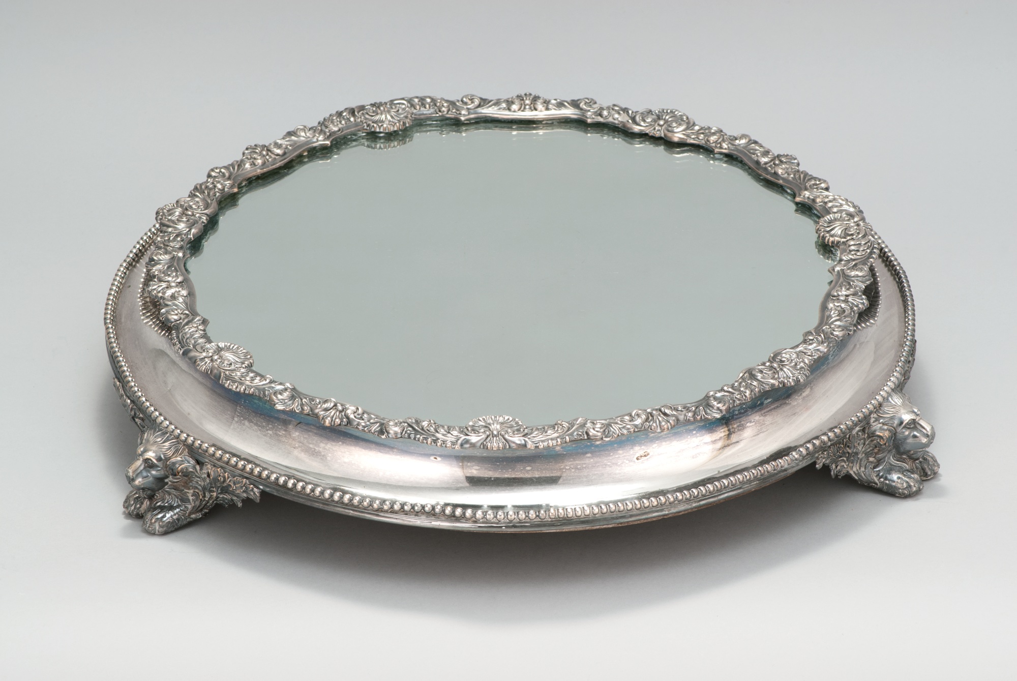 Appraisal: ENGLISH SILVER PLATED TABLE REFLECTOR th CenturyWith floral decoration and