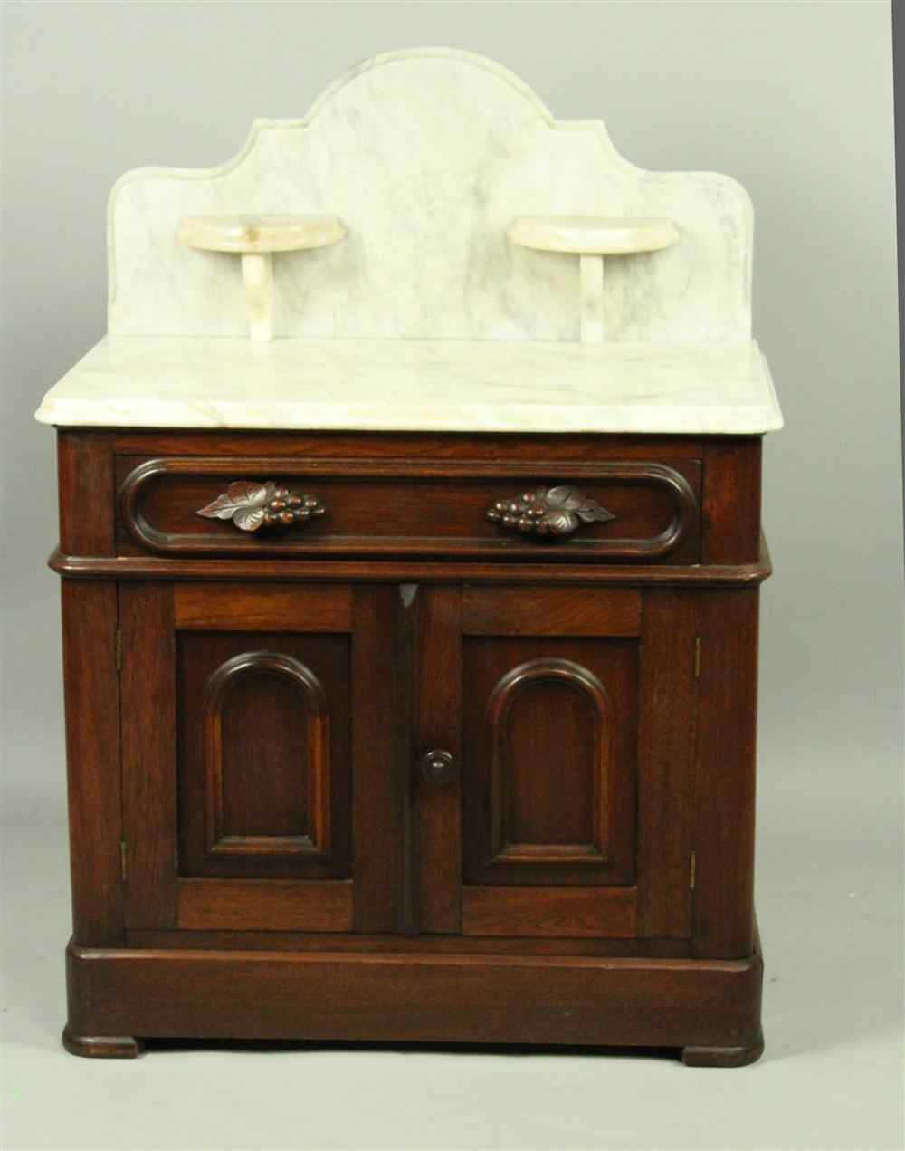 Appraisal: VICTORIAN AMERICAN PETITE WHITE MARBLE AND WALNUT WASHSTAND surmounted by