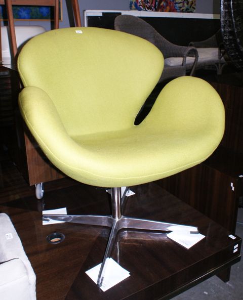 Appraisal: A green fabric upholstered Swan chair in the style of