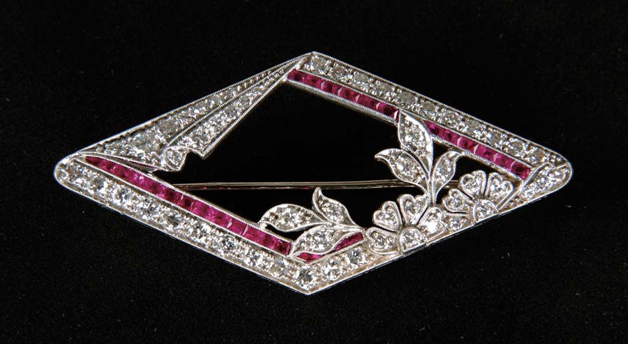 Appraisal: DIAMOND RUBY PIN Beautiful platinum pin is set with round