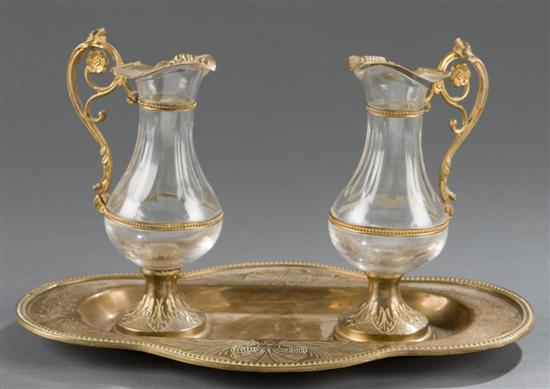 Appraisal: French gilt brass and crystal three piece oil and vinegar