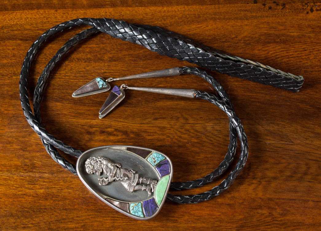 Appraisal: SIGNED NATIVE AMERICAN BOLO TIE with braided black leather cord