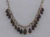 Appraisal: A carat yellow gold and smokey quartz fringe necklace the