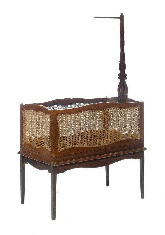 Appraisal: A PATENT MAHOGANY CHILD'S COT with caned sides and slatted