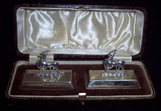 Appraisal: A pair of menu holders each modelled as the Warwickshire